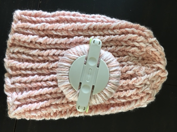 pink baby hat and pom pom maker