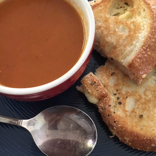 Homemade tomato soup and grilled cheese sandwich lunch