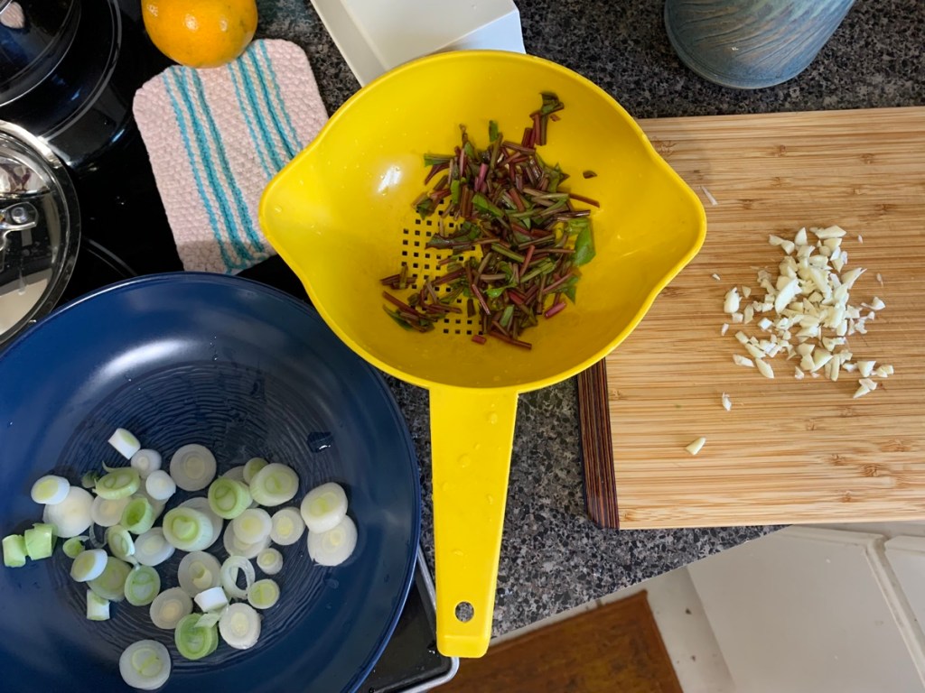 sliced onion, garlic and beet green stems
