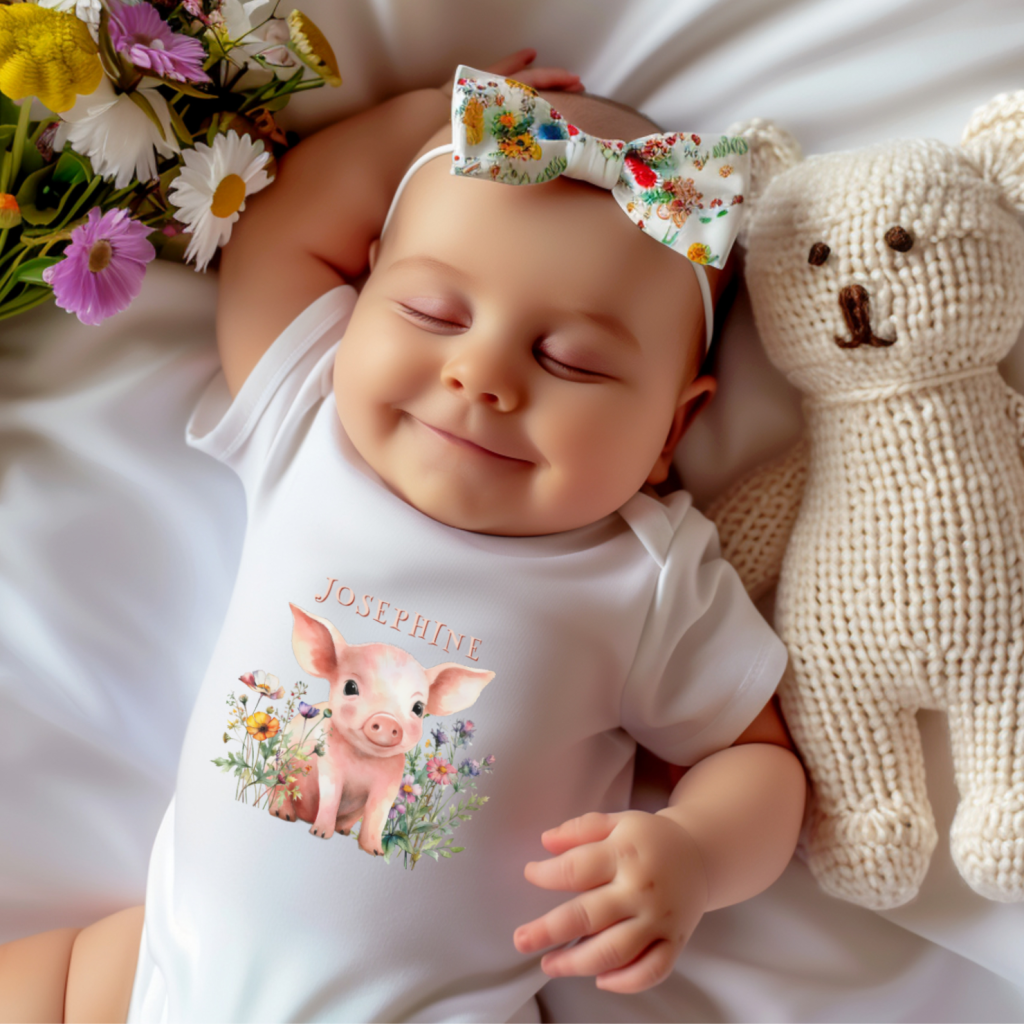 Onesie tee for new baby with piglet in wildflowers design. Add her name.