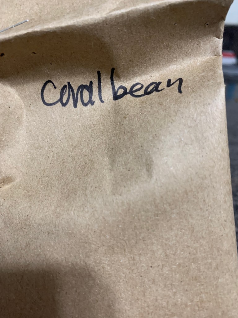 Paper bag with "coral bean" written on it.